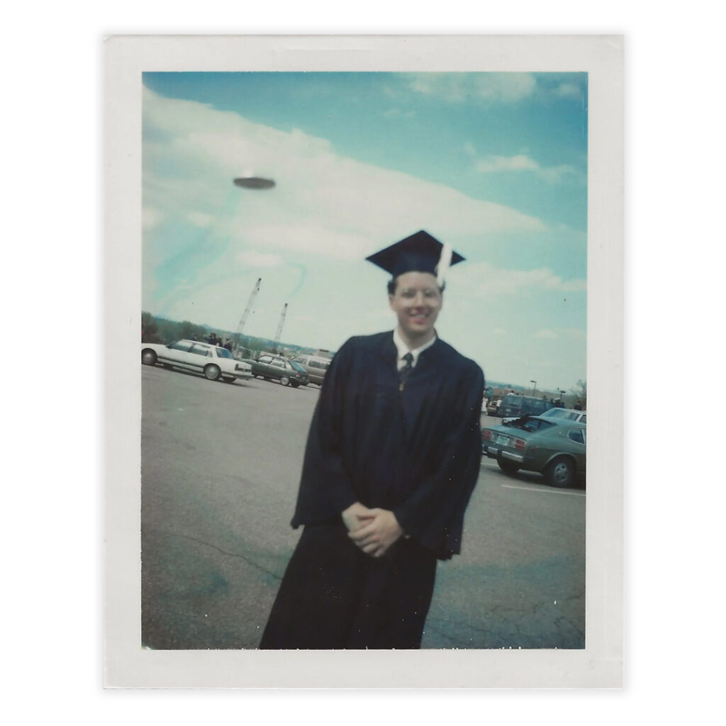 polaroid of Ben in graduation attire with a ufo over his shoulder by El Disco